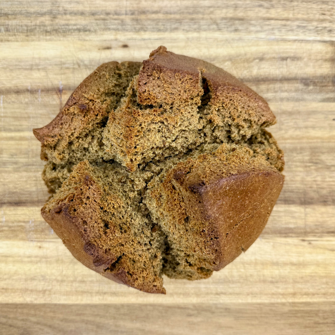 Circular loaf of soda bread on a wooden cutting board.