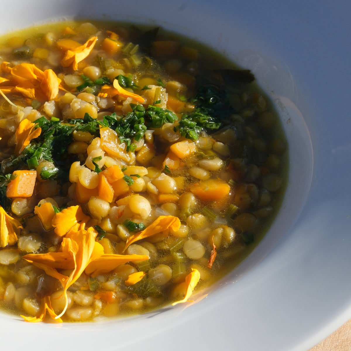 A white bowl with yellow split pea soup.